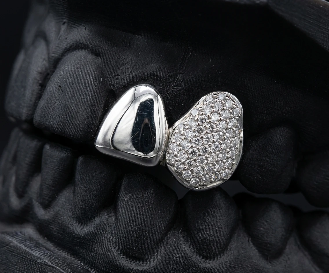 Iced canine paired with a solid lateral incisor in silver