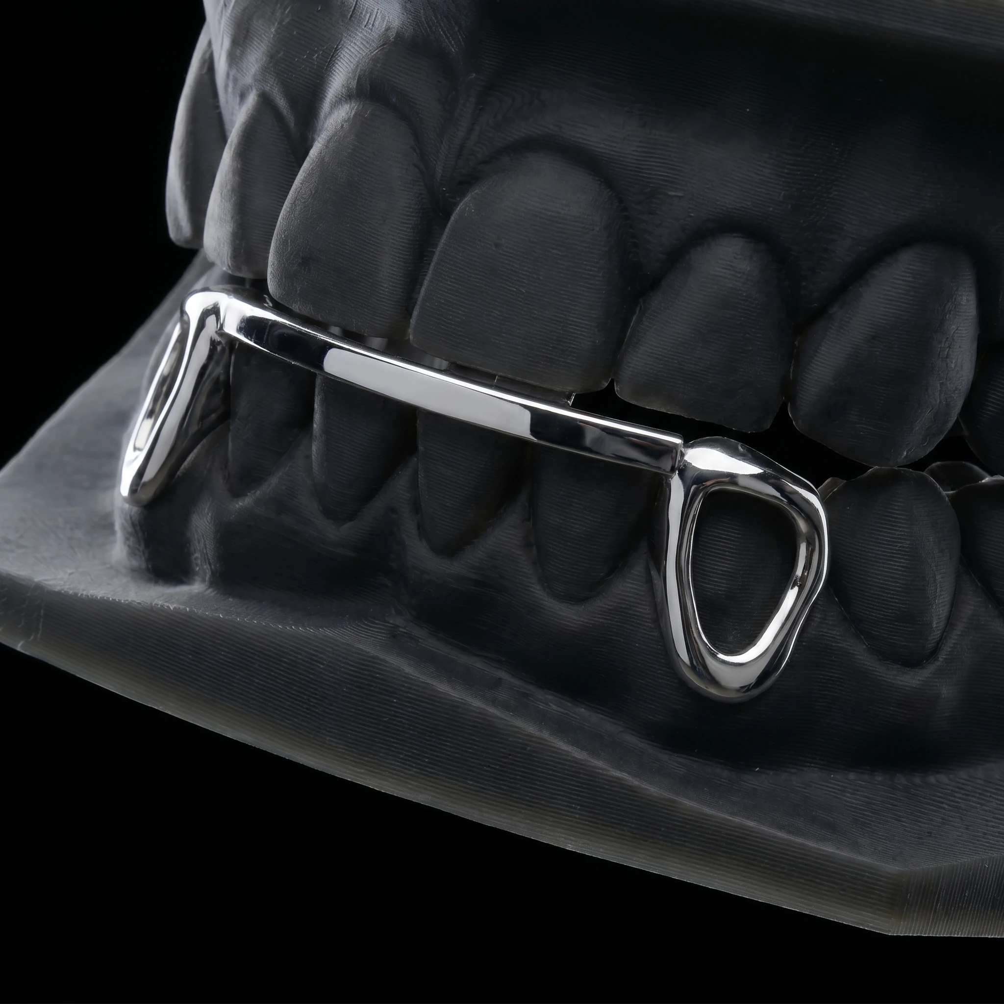 Window Bridge — open-face canines bridged by a plain bar, in silver